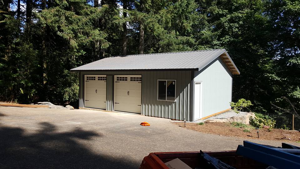 Picture of a pole building garage/workshop with two overhead doors.