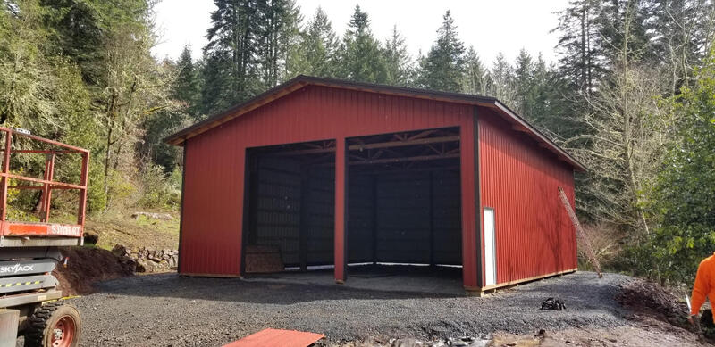 Picture of a red pole barn with two large overhead doors.
