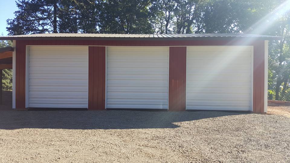 Picture of a red pole building with three overhead doors.